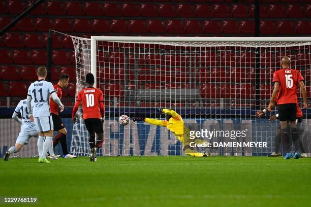 Rennes' Senegalese goalkeeper Alfred Gomis jumps to catch the ball during the UEFA Champions League Group E football match between Stade Rennais FC...