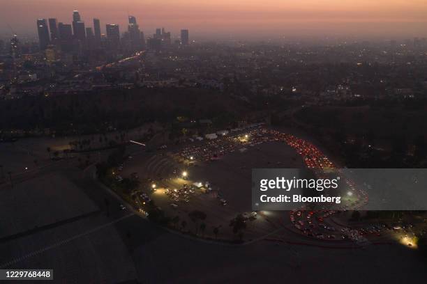 Cars line up at a Covid-19 drive-thru testing site in the parking lot of Dodger Stadium in Los Angeles, California, U.S., on Monday, Nov. 23, 2020....