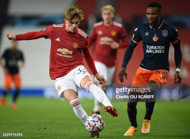 Manchester United's English defender Brandon Williams is challenged by Istanbul Basaksehir's Belgian defender Boli Bolingoli during the UEFA...