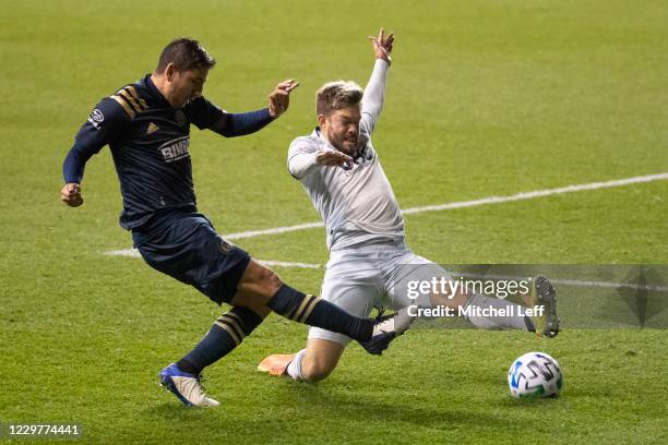 Alejandro Bedoya of Philadelphia Union passes the ball against Kelyn Rowe of New England Revolution in the second half during Round One of the MLS...