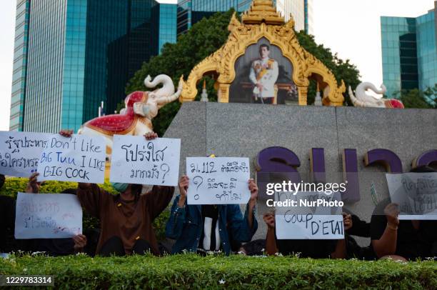 Pro-democracy protesters hold placards in front of the pictures of Thai King Maha Vajiralongkorn during a rally calling to reforms in the monarchy,...