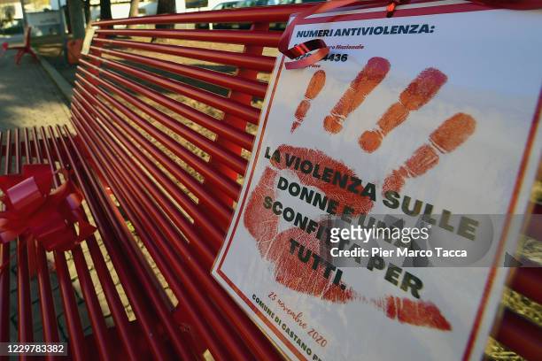 Sign against violence committed to women is displayed on a red bench on the 'International Day For The Elimination Of Violence Against Women' on...