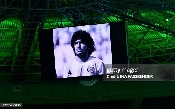 Portrait of Argentine football legend Diego Maradona is displayed on a giant screen prior to the UEFA Champions League group B football match...