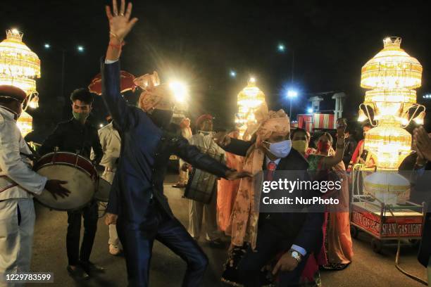 Groom's relatives dance during his wedding procession, amid the ongoing coronavirus pandemic, in Jaipur, Rajasthan,India, Wednesday, Nov. 25, 2020.