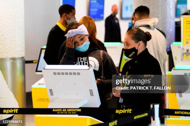 Passenger checks in for a Spirit Airlines flight at Los Angeles International Airport ahead of the Thanksgiving holiday in Los Angeles, California,...