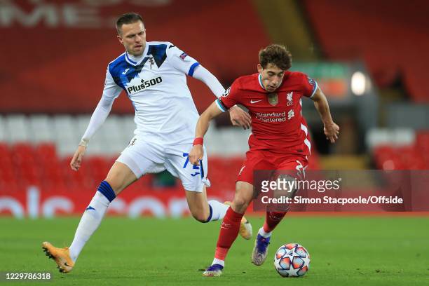 Josip Ilicic of Atalanta and Kostas Tsimikas of Liverpool during the UEFA Champions League Group D stage match between Liverpool FC and Atalanta BC...