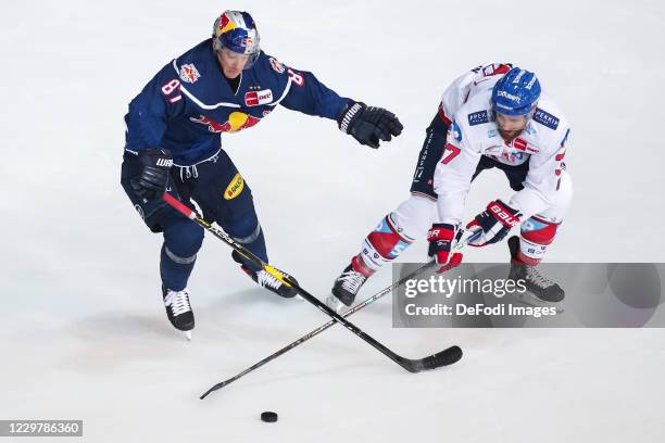 Philip Gogulla of EHC Red Bull Muenchen and Thomas Larkin of Adler Mannheim battle for the puck during the Magenta Sport Cup between EHC Red Bull...