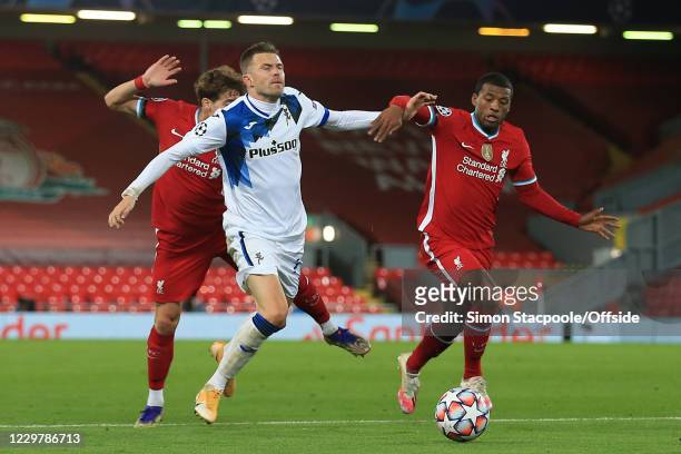 Josip Ilicic of Atalanta is brought down by Kostas Tsimikas and Georginio Wijnaldum of Liverpool but no penalty is given during the UEFA Champions...