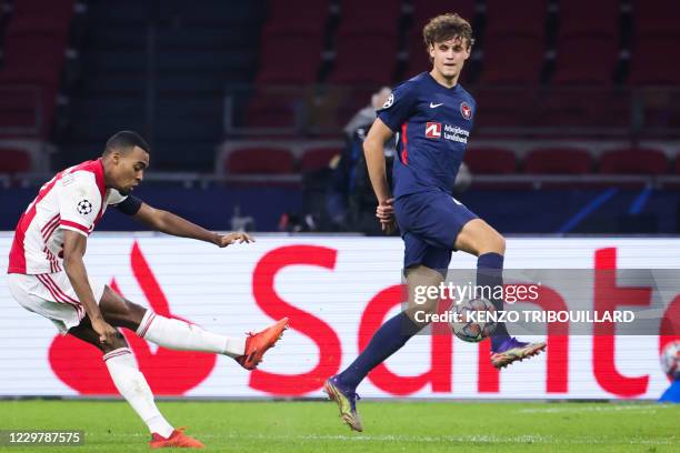 Ajax's Dutch midfielder Ryan Gravenberch shoots and scores a goal during the UEFA Champions League Group D football match between Ajax and FC...