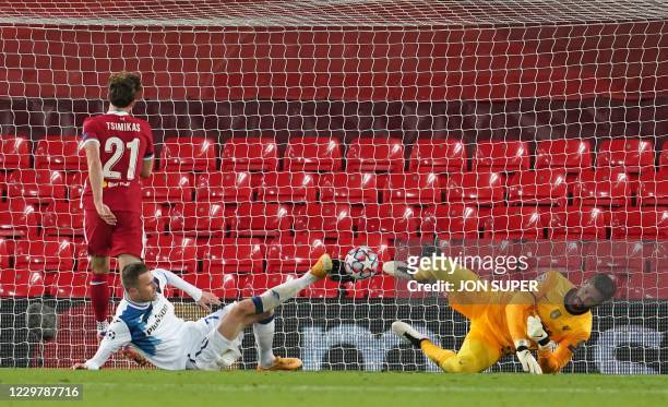 Atalanta's Slovenian forward Josip Ilicic scores past Liverpool's Brazilian goalkeeper Alisson Becker for the opening goal during the UEFA Champions...