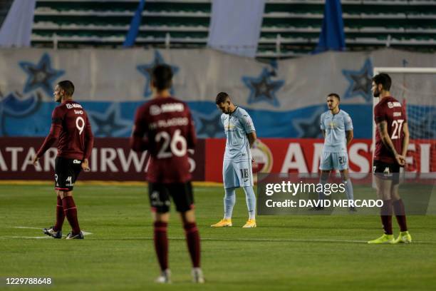 Players observe a minute of silence for the victims of Covid-19 coronavirus before the start of the closed-door Copa Sudamericana round before the...