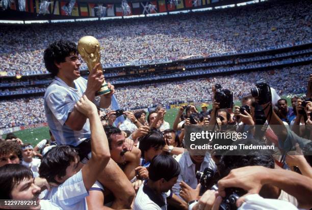 World Cup: Argentina Diego Maradona victorious with teammates carrying world cup trophy after winning Finals match vs West Germany at Estadio Azteca....