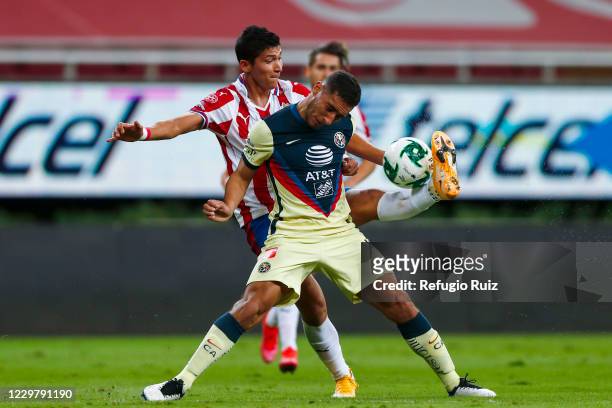 Angel Saldívar of Chivas fights for the ball with Sebastián Cáceres of America during the quarterfinals first leg match between Chivas and America as...
