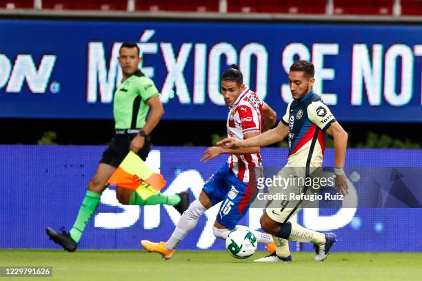 Carlos Antuna of Chivas fights for the ball with Sebastián Cáceres of America during the quarterfinals first leg match between Chivas and America as...