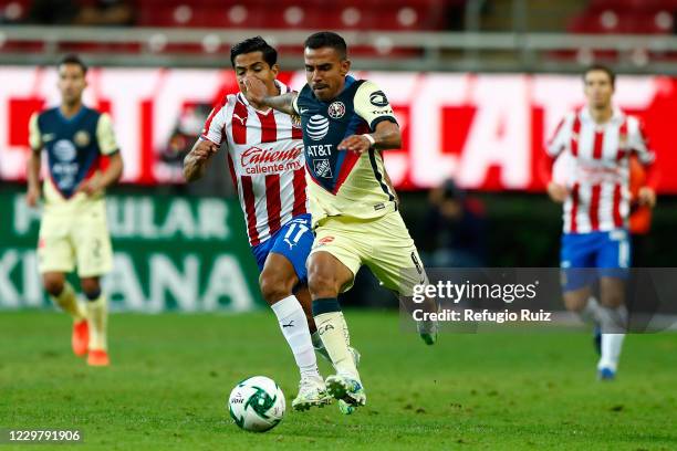 Jesus Sanchez of Chivas fights for the ball with Jesús Escoboza of America during the quarterfinals first leg match between Chivas and America as...