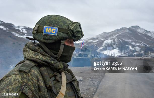 Russian soldiers of the peacekeeping force man a checkpoint on a road outside the town of Stepanakert on November 26 after six weeks of fighting...