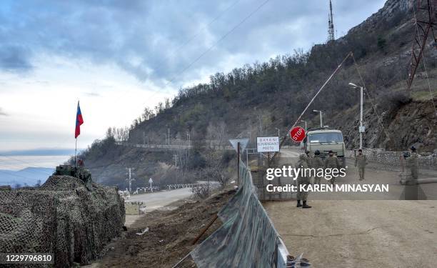 Soldiers of the Russian peacekeeping force and Azerbaijan's army man a checkpoint outside the town of Shusha on November 26 after six weeks of...