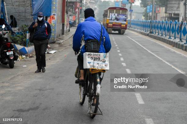 Newspaper boy carries away newspaper with headline of the sudden demise of the football legend.The 60 year old football superstar passed away after...