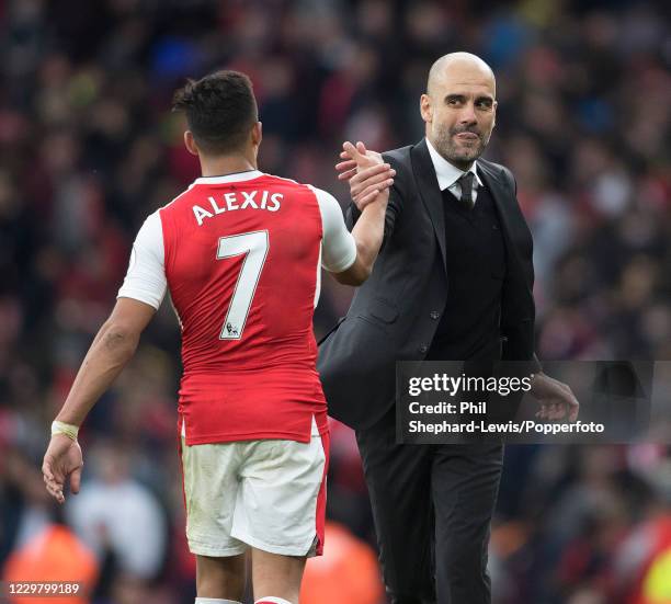 Alexis Sanchez of Arsenal shakes hands with Manchester City manager Pep Guardiola after the Premier League match between Arsenal and Manchester City...