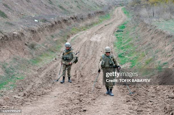 Azerbaijan military sappers clear mines in a countryside outside the town of Fuzuli on November 26, 2020. - The territory is due to be returned to...