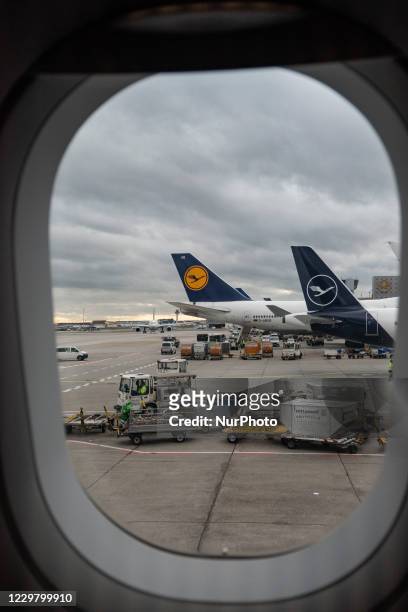 Tail lineup, row of Lufthansa aircraft with the logo visible as seen from an plane window at Frankfurt International Airport FRA. The former german...
