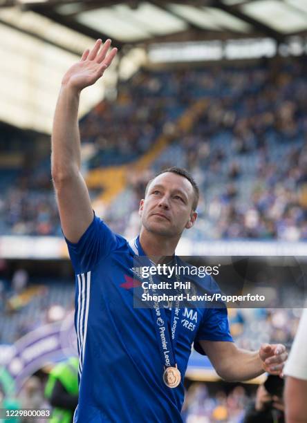 John Terry of Chelsea waves to the crowd wearing his Premier League medal after the Premier League match between Chelsea and Sunderland at Stamford...