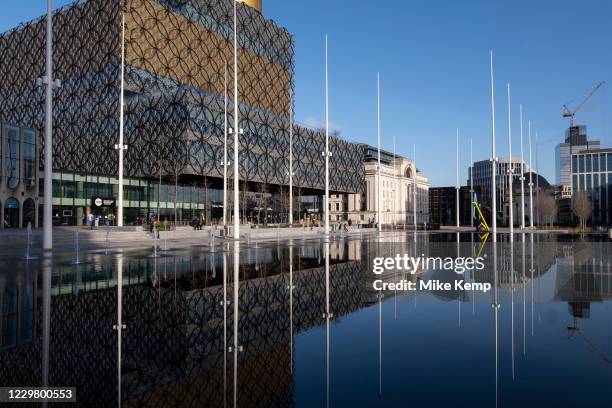 Public space reflections of the fountains looking towards the Library of Birmingham in Centenary Square in the City Centre on the day it was...