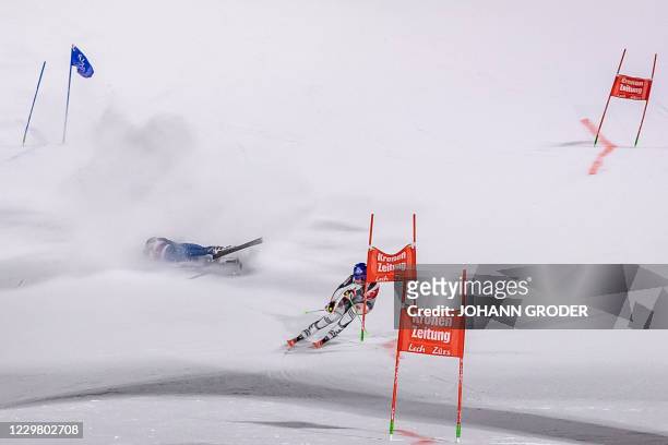Paula Moltzan of the USA falls as Slovakia's Petra Vlhova goes on to win the women's parallel slalom of the FIS ski alpine world cup in Lech, Austria...