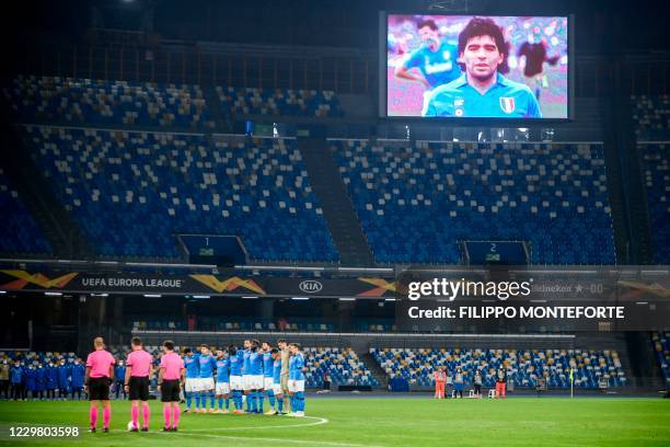 Screen displays a photo of late Argentinian football legend Diego Maradona as players hold a minute of silence in homage to Maradona prior to the...