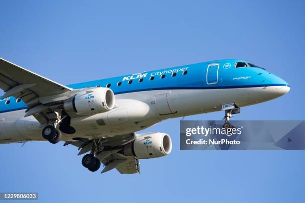 Cityhopper Embraer ERJ-175 regional aircraft as seen on final approach flying and landing in Amsterdam Schiphol AMS EHAM international airport during...
