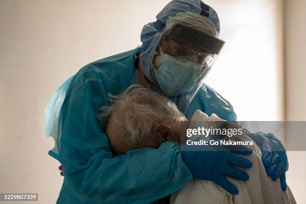 Dr. Joseph Varon hugs and comforts a patient in the COVID-19 intensive care unit during Thanksgiving at the United Memorial Medical Center on...