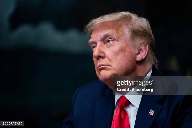 President Donald Trump listens during a videoconference with members of military in the Diplomatic Room of the White House in Washington, D.C., U.S.,...