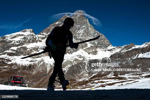 Professional skier is silhouetted against the Matterhorn summit in the alpine ski resort of Breuil-Cervinia, Northwestern Italy, on November 25,...