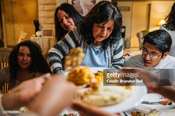 Virginia Bautista prepares food with her family for a gathering on November 26, 2020 in Los Angeles, California. Families have adjusted plans under...