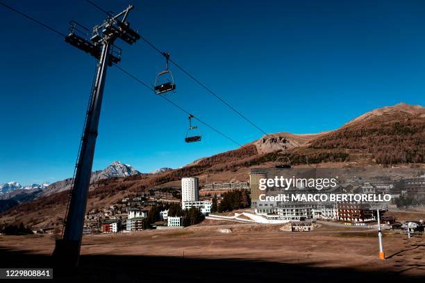 General view shows a chairlift in the alpine ski resort of Sestriere , Northwestern Italy, on November 26, 2020. - Closed shops, hotels and...