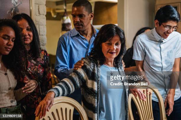 Dr. Christopher Broughton and Virginia Bautista stand with their family during a gathering on November 26, 2020 in Los Angeles, California. Families...