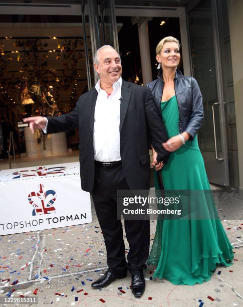 Philip Green, the billionaire owner of Arcadia Group Ltd., left, stands with British fashion model Kate Moss, ahead of the opening of the Topshop...