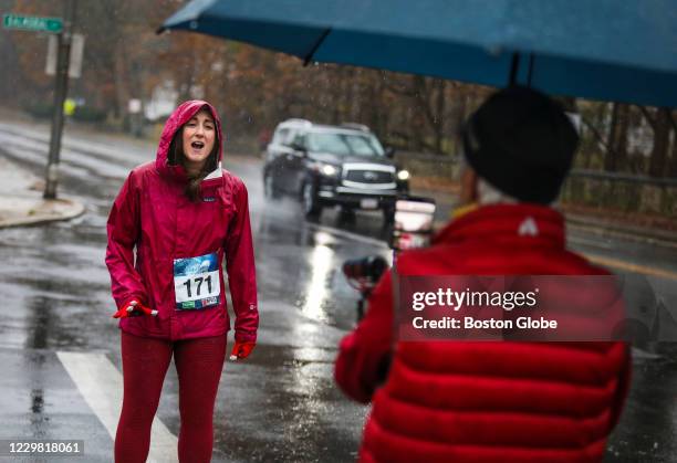 Sue Parke sings the Star Spangled Banner while being livestreamed to online viewers at the beginning of the annual Feaster Five Thanksgiving Race in...