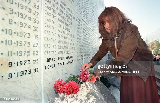 Santiago resident deposits flowers at the memorial for the detained and disappeared, 09 May 1999, in remembrance of the mothers, victims of the...