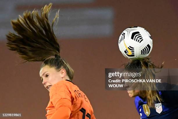 United States' defender Kelley Ohara heads the ball next to Netherlands' forward Lieke Martens during the women's friendly football match between the...