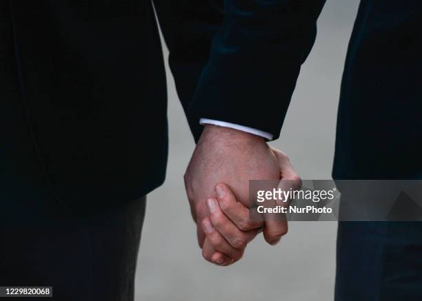 Happy Mark and Cathal walking hand in hand next to Government Buildings just after taking their wedding vows in Dublin's city centre. On Friday,...