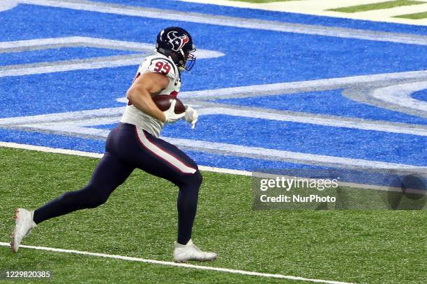 Houston Texans defensive end J.J. Watt runs the ball in for a touchdown during the first half of an NFL football game between the Detroit Lions and...