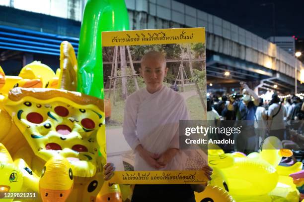 Pro-democracy protester holds a portrait of Srirasmi Suwadee during an anti-government demonstration in Bangkok, Thailand on November 27, 2020....