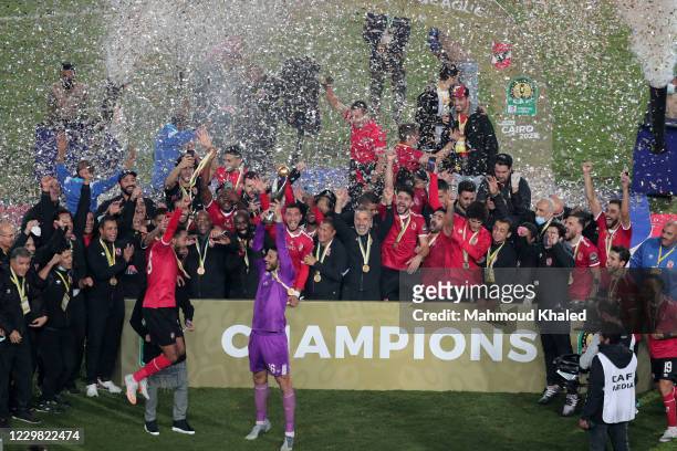 Players of Al Ahly celebrate with the trophy of CAF Champions League after winning the final match between Zamalek and Al Ahly at Cairo stadium on...
