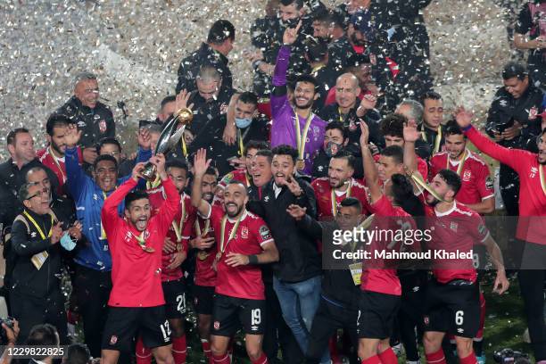 Players of Al Ahly celebrate with the trophy of CAF Champions League after winning the final match between Zamalek and Al Ahly at Cairo stadium on...
