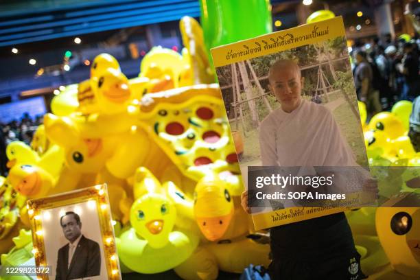 Pro-democracy protester holds a portrait of former Princess Srirasmi Suwadee during an anti-government demonstration in the Thai capital. Thousands...