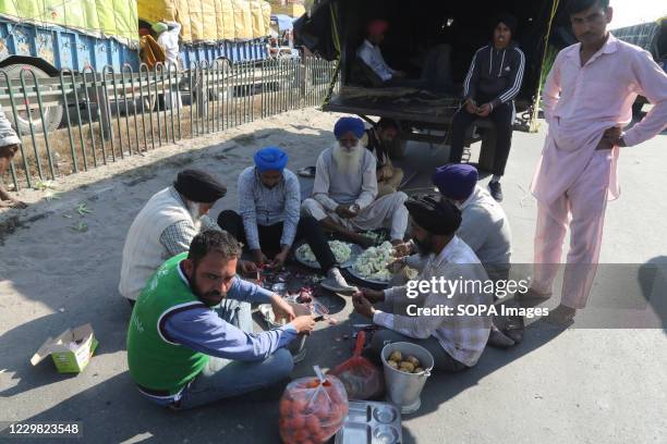 Protesters preparing food after police forces stopped them from marching towards New Delhi during the demonstration. Groups of farmers marched from...