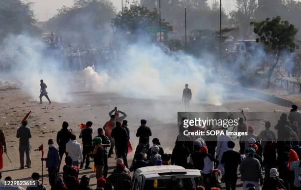 Police force firing tear gas to disperse protesters during the demonstration. Groups of farmers marched from Singhu border Delhi-Haryana border...