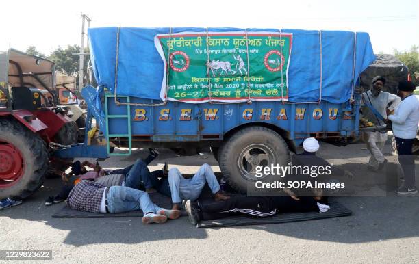 Protesters resting after police forces stopped them from marching towards New Delhi during the demonstration. Groups of farmers marched from Singhu...