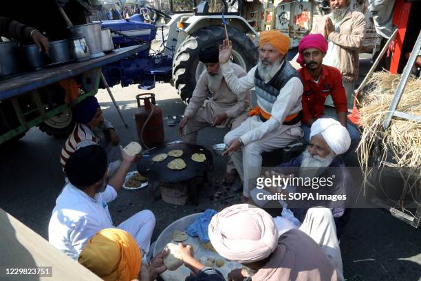 Protesters preparing food after police forces stopped them from marching towards New Delhi during the demonstration. Groups of farmers marched from...